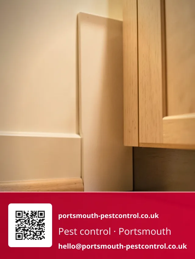 Discreet bait point tucked behind a kitchen plinth kick panel