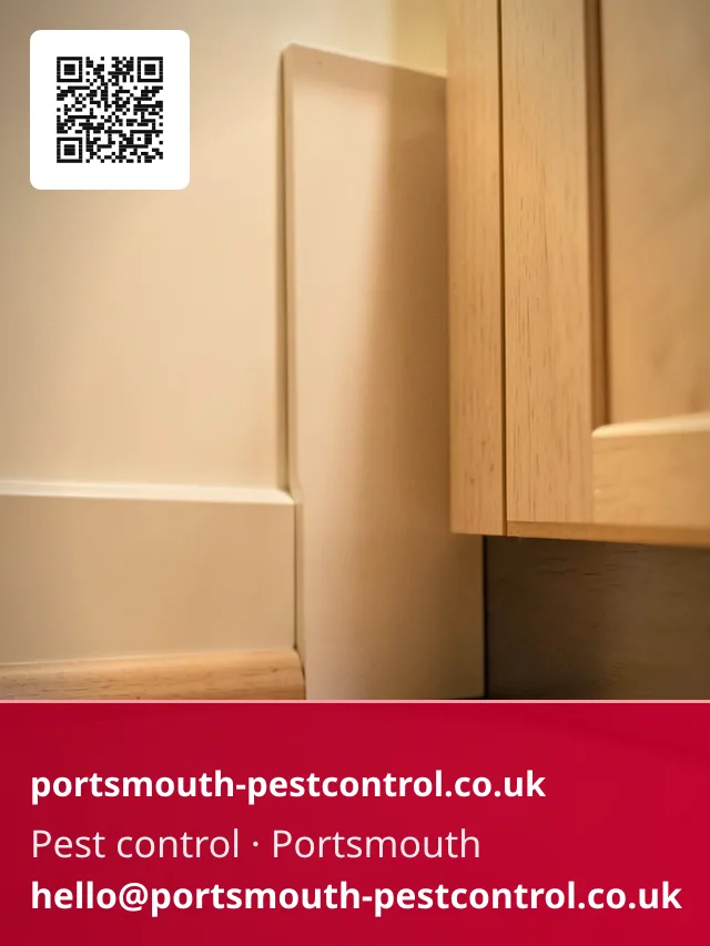 Discreet bait point tucked behind a kitchen plinth kick panel