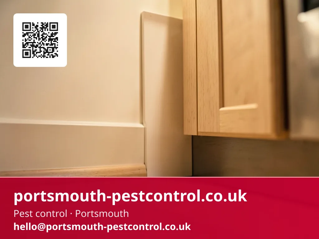 Discreet bait point tucked behind a kitchen plinth kick panel