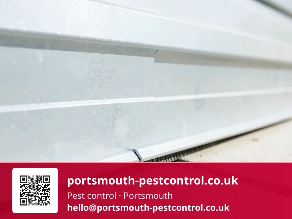Brush seal strip being fitted along the base of a garage door
