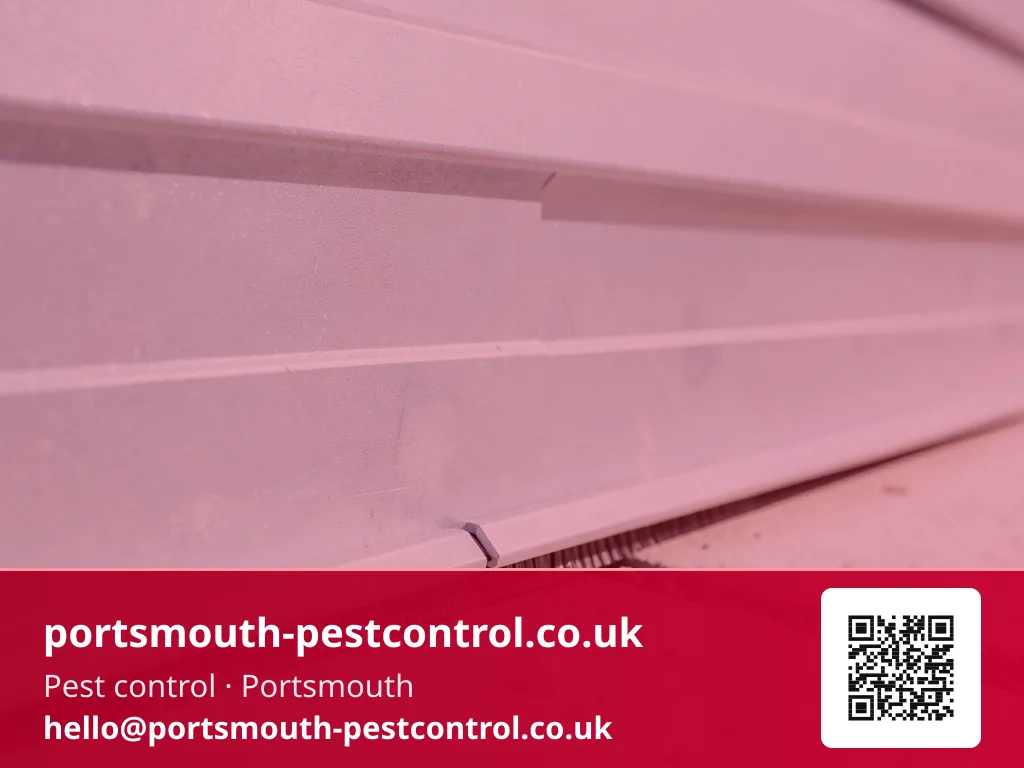 Brush seal strip being fitted along the base of a garage door